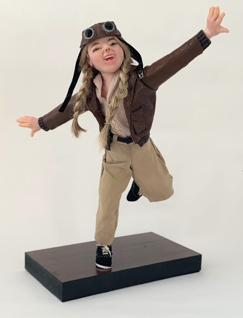 Young girl doll pretending to fly.