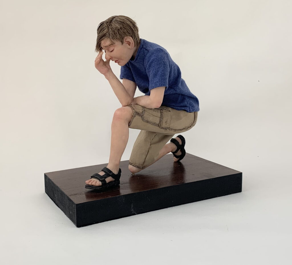 Young man kneeling.