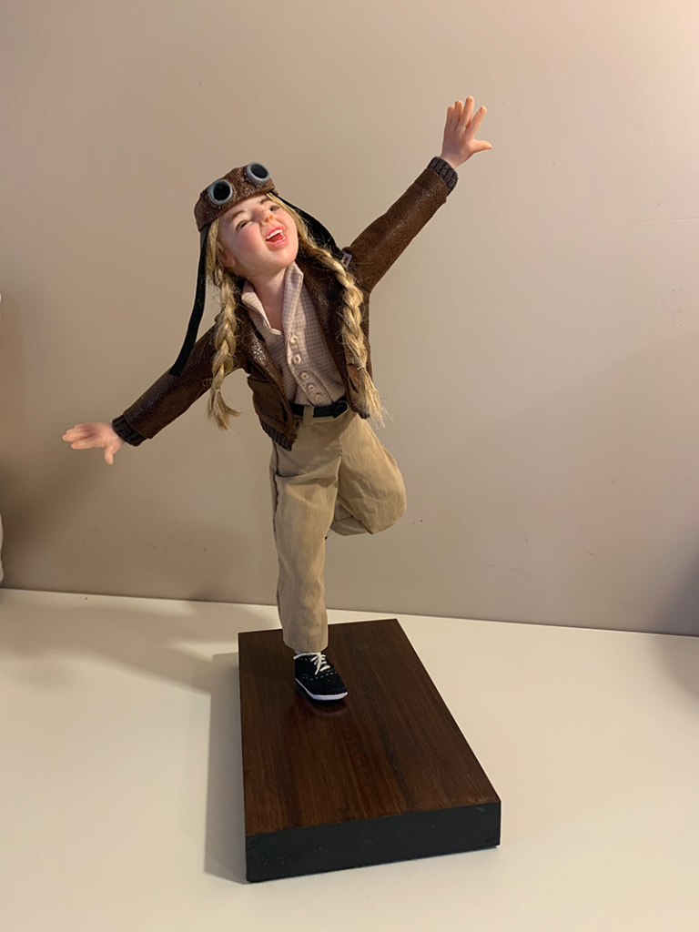 A picture of a handmade doll who resembles Amelia Earhart