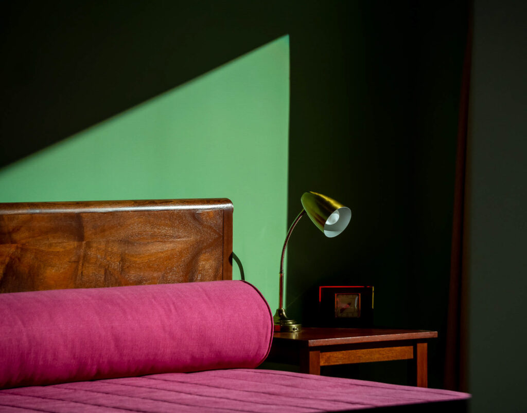 A photo of a bedroom with a beam of light shining in.