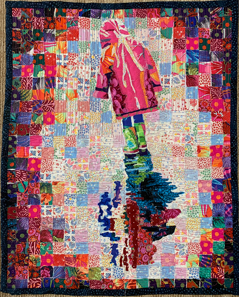 Picture of a quilt of a child walking in the rain